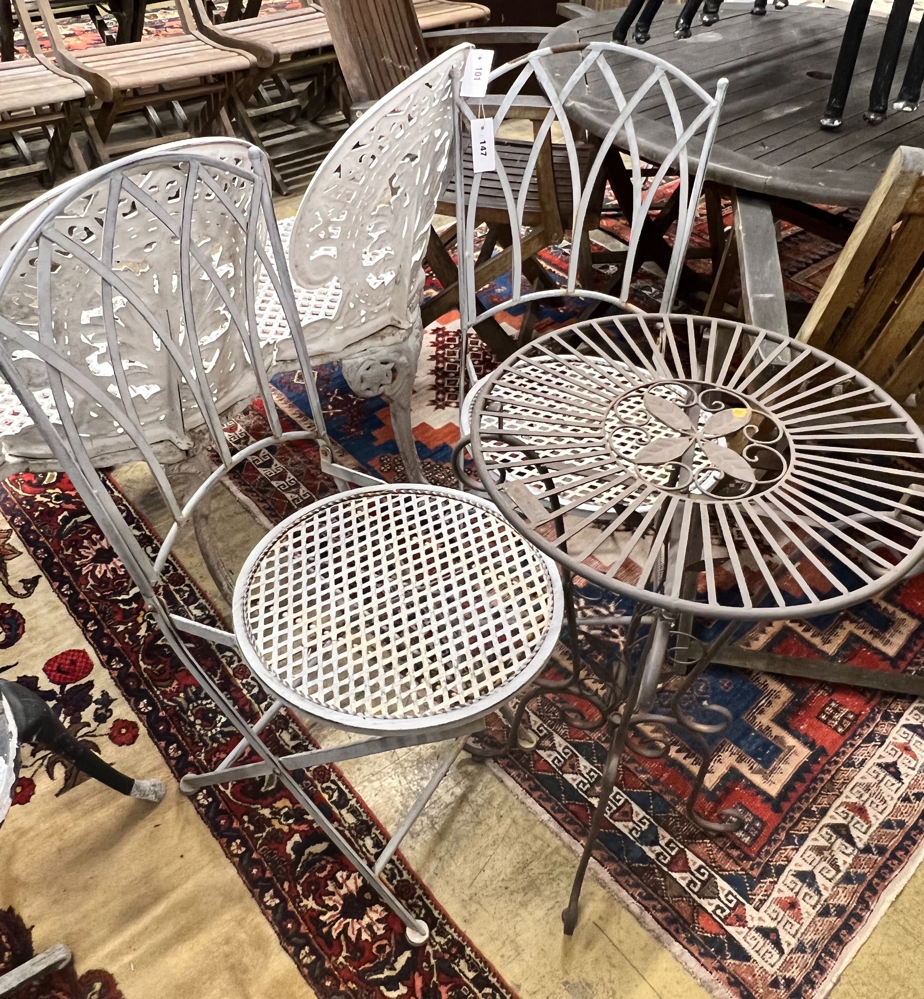 A Laura Ashley circular metal garden table, diameter 43cm, together with two folding garden chairs